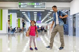 father and little daughter walking in the airport, family travel photo