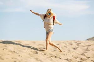 Adult woman hiking and backpacking in beautiful desert and rocky landscape photo