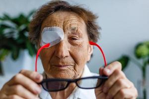 elderly woman with one eye surgery photo