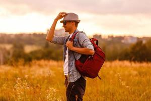 Portrait Of Man Hiking In Countryside Wearing Backpack photo