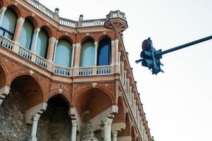 Facades of old Italian buildings in old part of town, windows with shutters, old building in Genoa, Italy. photo