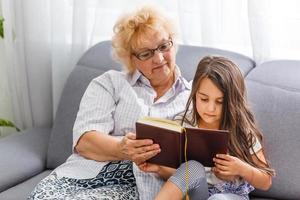 Grandmother and granddaughter reading photo