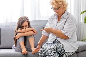 nanny scolding at little girl at home interior photo