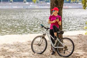 Use smart phone app for navigation while bike ride on the forest trail photo