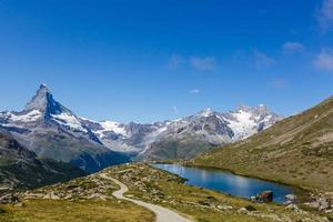 Amazing view of touristic trail near the Matterhorn in the Swiss Alps. photo