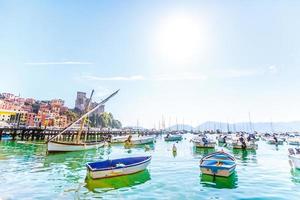 Fishing Boats in Liguria Italy. Small fishing boats with fishing equipment docked in the port - Lerici, La Spezia, Liguria, Italy photo