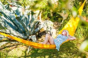 Blonde woman relaxing in a hammock. photo