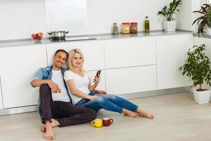 Coronavirus. A couple sitting on a sofa on a quarantine at home Couple at home looking each other, both wear masks because of avoiding contagion. Stay at home. Romantic. photo