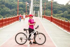 Young beautiful woman on a bicycle photo