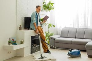 He cleaned the carpet, vacuum cleaner. photo