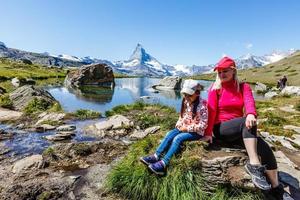 Traveler in the Alpine meadow, Switzerland photo