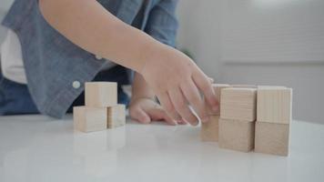 Child play with toy blocks.  Asian boys enjoy playing with building blocks. Educational game for baby and toddler to home preschool, school, kindergarten or nursery. Portrait child or little kid video
