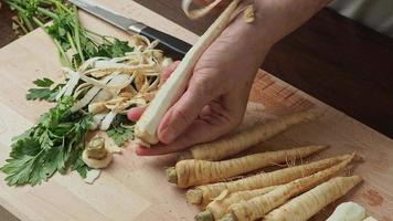 Slicing parsley root. Fresh parsley root on cutting board video