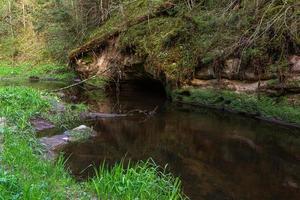 a Small Forest Stream With Sandstone Cliffs and Stones photo