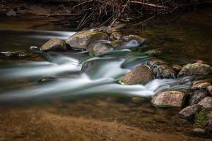 a Small Forest Stream With Sandstone Cliffs and Stones photo