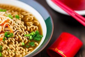 Delicious noodles. Fast food meal with appetizing pasta and chopsticks. photo