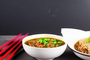 Delicious noodles. Fast food meal with appetizing pasta and chopsticks. photo