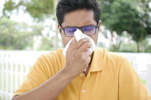 Sick man got flu allergy sneezing and blowing nose photo