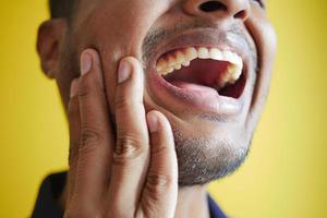 young man with sensitive teeth close up photo