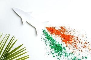 Concept for Indian Independence day and republic day, view of flying missile with tricolor on white background photo