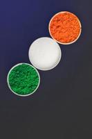 Concept for Indian Independence day and republic day tricolor in cup on dark background photo