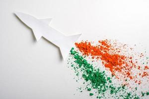 Concept for Indian Independence day and republic day, view of flying missile with tricolor on white background photo