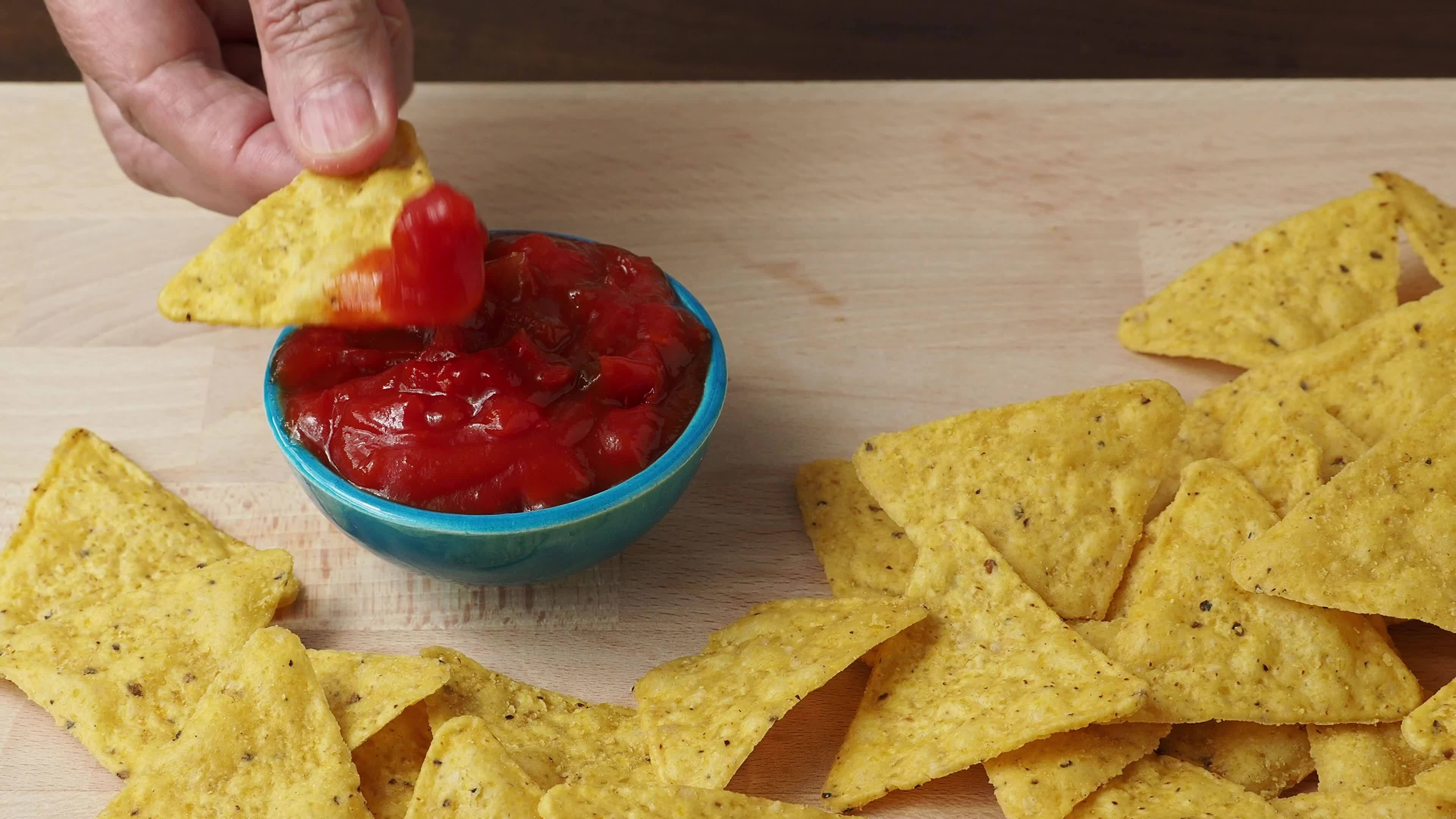 Tortilla chips with spicy tomato salsa 16785999 Stock Video at Vecteezy