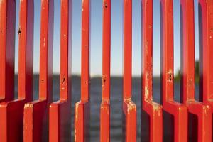 Red bench in detail. Texture of vertical lines. photo