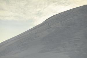 Snowy slope. Snowdrifts in winter. Slide of snow. photo