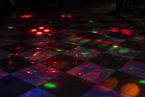 Disco dance floor. Light on dance floor. Colored spots on floor. Lights from spotlight. photo