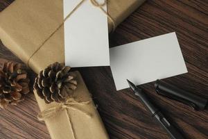 Recycled paper wrapped birthday gift boxes are being prepared on the table, top view, flatlay. photo