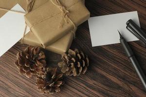 Recycled paper wrapped birthday gift boxes are being prepared on the table, top view, flatlay. photo