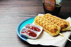 waffle sticks Corn dogs Hot Dog Waffles on a Stick  Ketchup on a wooden table photo