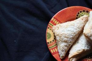 Turnovers Apple, Apple Pie, Served in an Orange Plate on a black cloth background, Turnovers Apple is a popular dish in America - Flat-Lay.