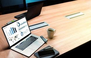 Top view slide show presentation on display laptop with coffee cup on table in meeting room photo