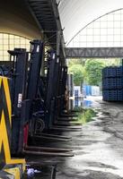 Forklift trucks row parked in warehouse. photo