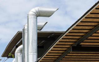 Chimney ventilation system on outside building photo