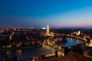 Verona, Italy - panorama by night. Illuminated cityscape with scenic bridge. photo