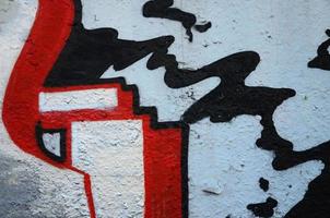 Texture of a fragment of the wall with graffiti painting, which is depicted on it. An image of a piece of graffiti drawing as a photo on street art and graffiti culture topics