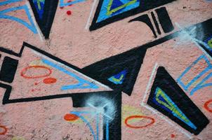 Background image of the wall decorated with colorful abstract graffiti. Street art concept photo