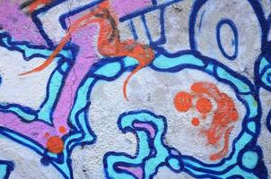 Texture of a fragment of the wall with graffiti painting, which is depicted on it. An image of a piece of graffiti drawing as a photo on street art and graffiti culture topics