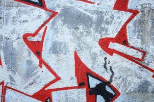 Texture of a fragment of the wall with graffiti painting, which is depicted on it. An image of a piece of graffiti drawing as a photo on street art and graffiti culture topics