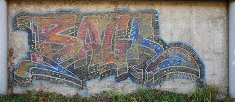 The texture of the wall with graffiti, which is depicted on it. The image of the whole and complete graffiti of the drawing as a resource for the design of 3D projects photo