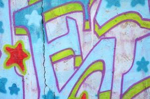 Texture of a fragment of the wall with graffiti painting, which is depicted on it. An image of a piece of graffiti drawing as a photo on street art and graffiti culture topics