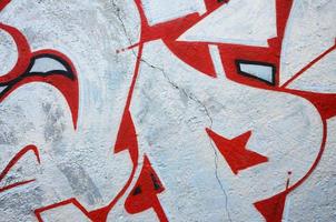 Texture of a fragment of the wall with graffiti painting, which is depicted on it. An image of a piece of graffiti drawing as a photo on street art and graffiti culture topics