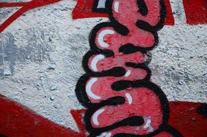 Texture of a fragment of the wall with graffiti painting, which is depicted on it. An image of a piece of graffiti drawing as a photo on street art and graffiti culture topics