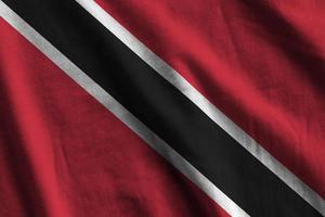 Trinidad and Tobago flag with big folds waving close up under the studio light indoors. The official symbols and colors in banner photo