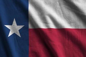 Texas US state flag with big folds waving close up under the studio light indoors. The official symbols and colors in banner photo