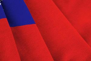 Taiwan flag with big folds waving close up under the studio light indoors. The official symbols and colors in banner photo