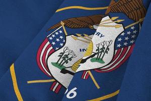 Utah US state flag with big folds waving close up under the studio light indoors. The official symbols and colors in banner photo